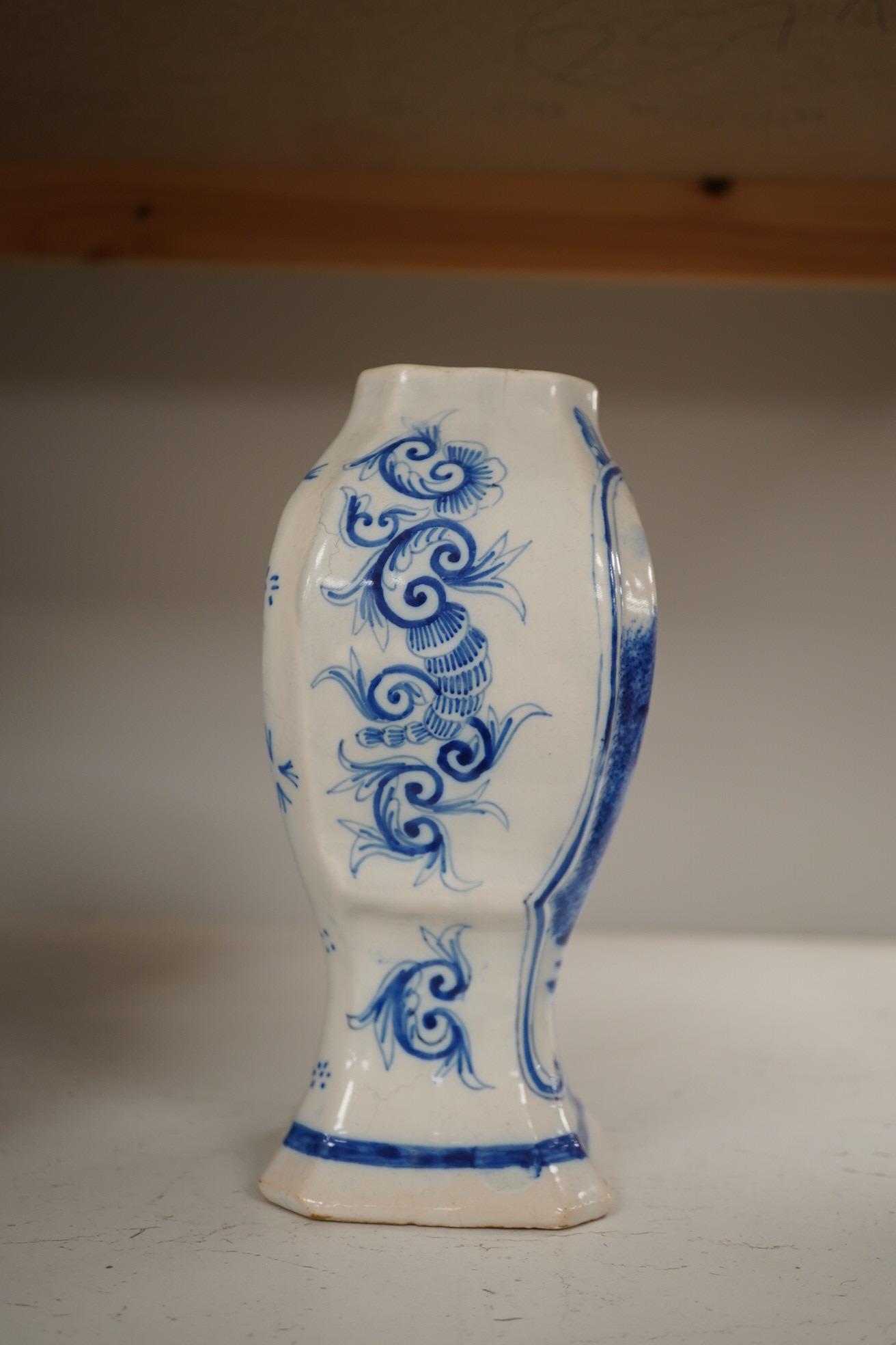 A 19th century Delft blue and white vase and a Watcombe Torquay pottery chamberstick, 19.5cm. Condition - both fair